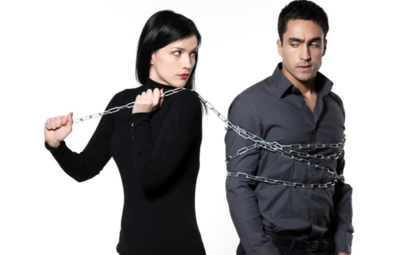 woman binding his man with a chain on white background